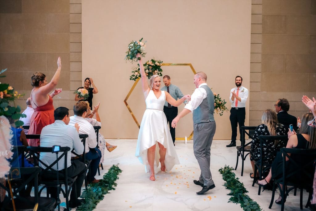 Bride and groom walking aisle at DoveCote Wedding - Orlando