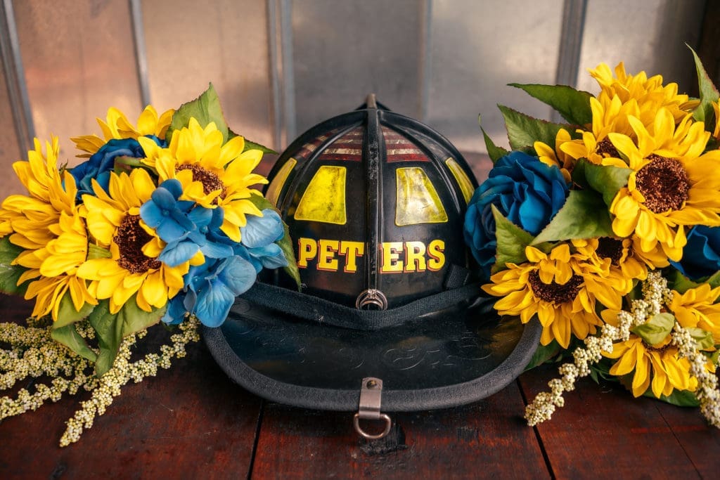 Wedding rings on Firefighter Helmet at Knotted Roots on the Lake