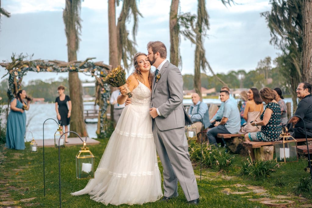Bride and Groom in Aisle at Knotted Roots on the Lake - Land O' Lakes