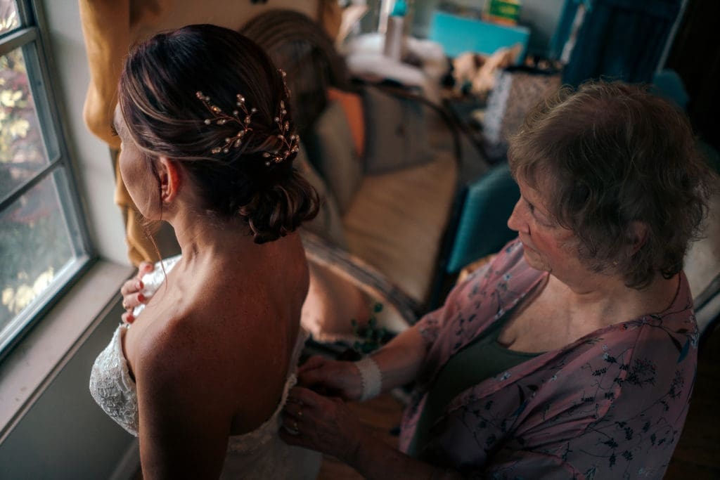 Bride with mother in bridal suite at Knotted Roots on the Lake - Land O' Lakes