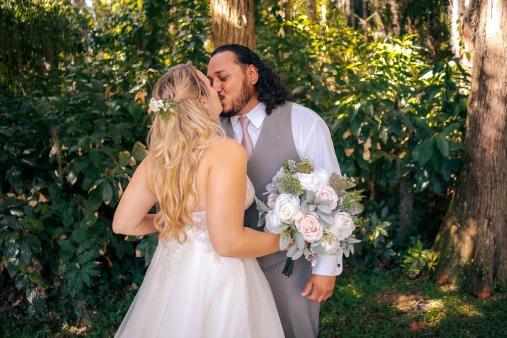 Bride and Groom kissing at Knotted Roots on the Lake