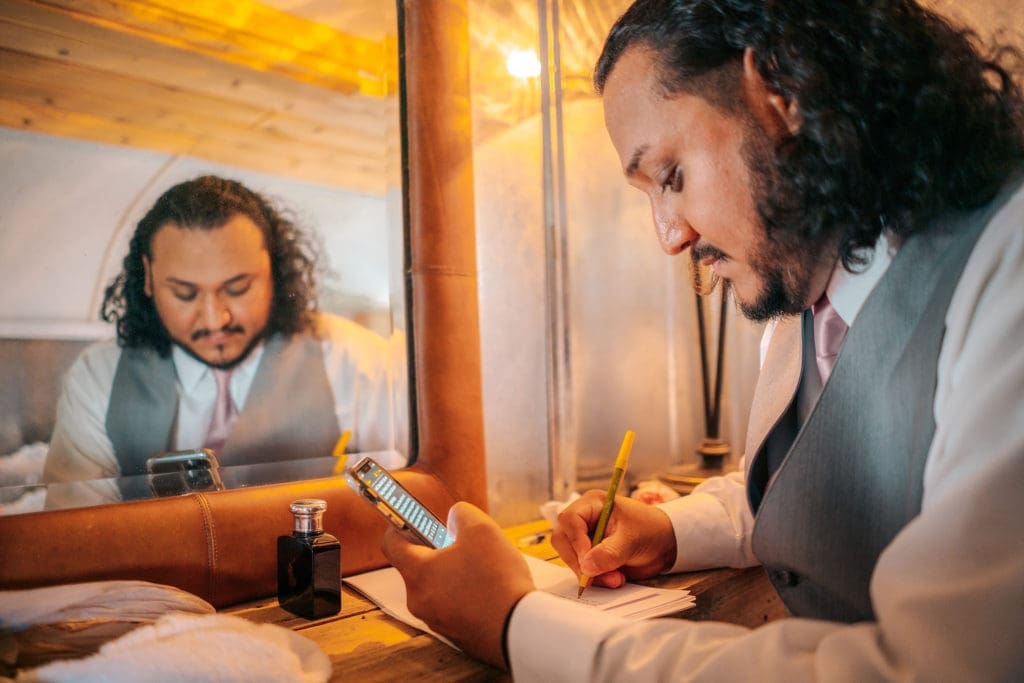 Groom writing vows at Knotted Roots on the Lake