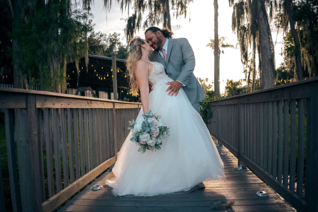 Bride and Groom Kissing on Dock at Knotted Roots on the Lake