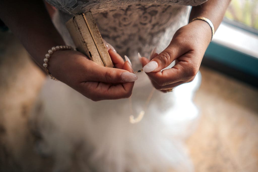 Bride holding jewelry before wedding in St. Pete