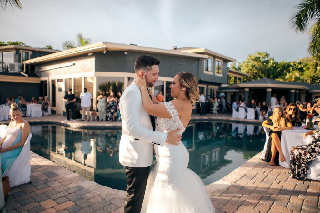 Bride and Groom dancing at reception next to pool at St. Pete Wedding