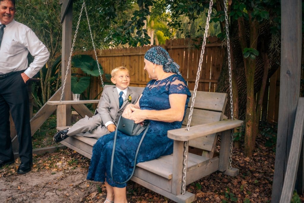 Ring Bearer and Grandma on bench at Knotted Roots on the Lake